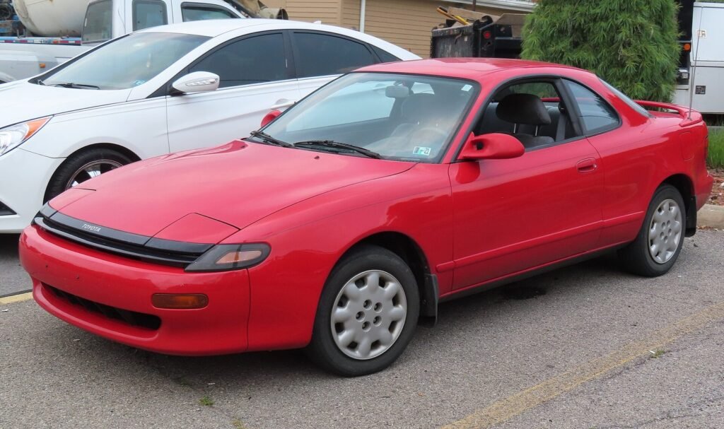 Red fifth-generation Toyota Celica coupé parked in a car park